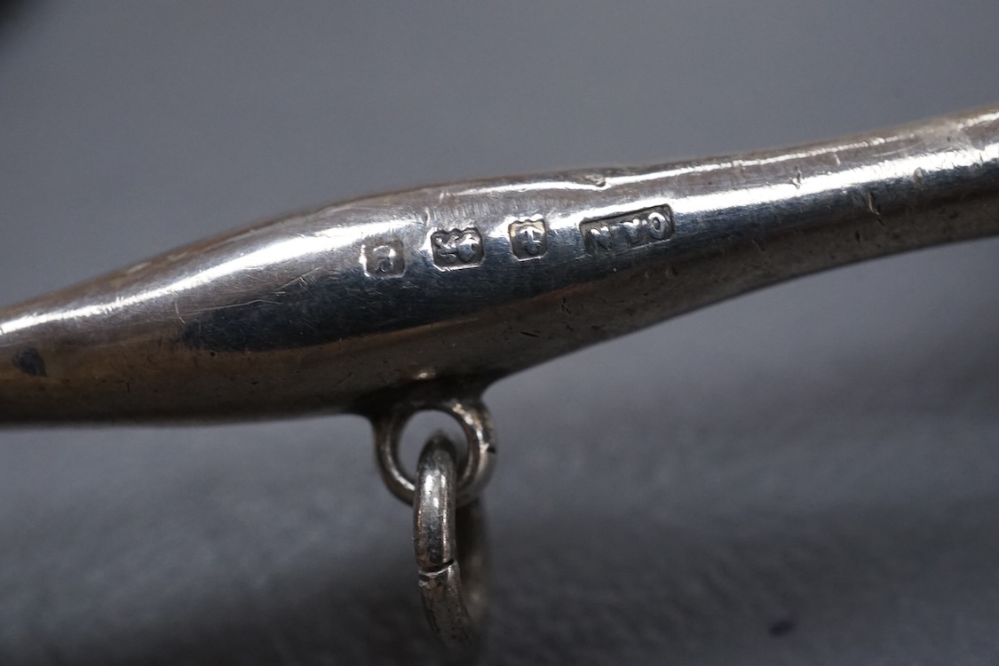 An Edwardian silver child's rattles, of dumbbell form, Crisford & Norris, Birmingham, 1906, 11cm, together with a 20th century Egyptian 900 standard white metal dish, post 1946 mark,(lead solder).